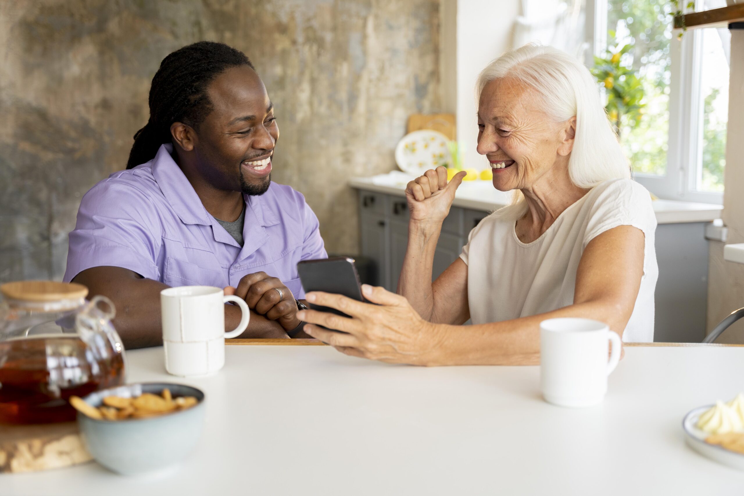 african social worker helping senior woman scaled.jpg